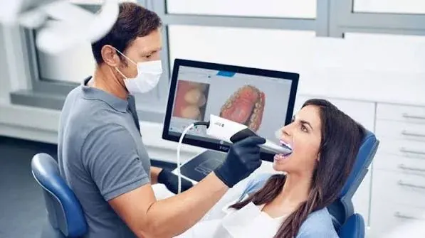 A digital intraoral scanner recording the shape of the teeth chairside